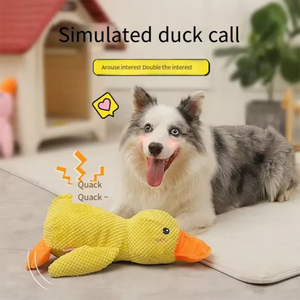 Dog happily playing with an interactive duck dog toy that makes quacking sounds to engage pets.